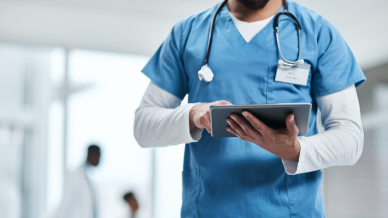 Hospital, doctor hands and tablet with a man in a clinic reading healthcare and wellness data. Employee, nurse and Male person with digital and health results on technology with research analysis