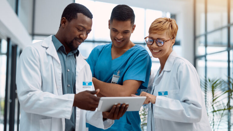 Doctor, team and tablet in healthcare planning for research, idea or meeting on technology at hospital. Happy group of doctors with touchscreen for medical data, collaboration or teamwork strategy