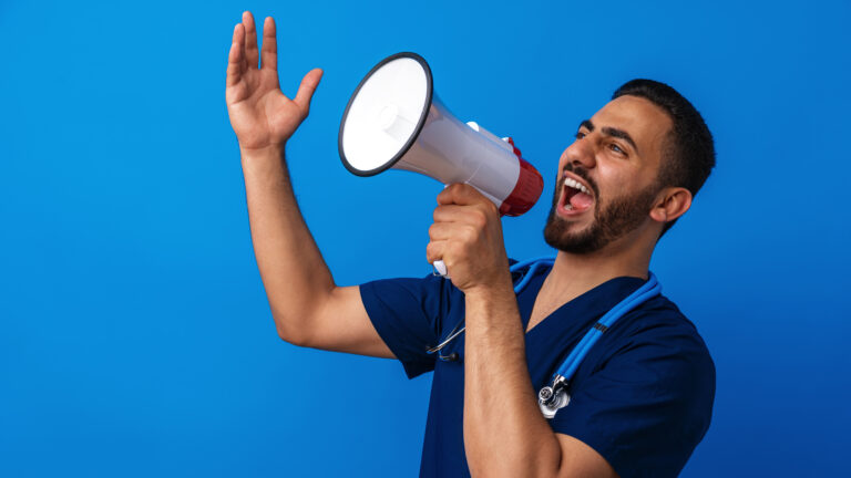 Arab man doctor in uniform screaming in megaphone against blue background