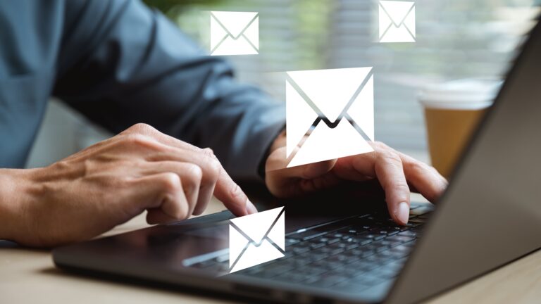person sending emails on computer