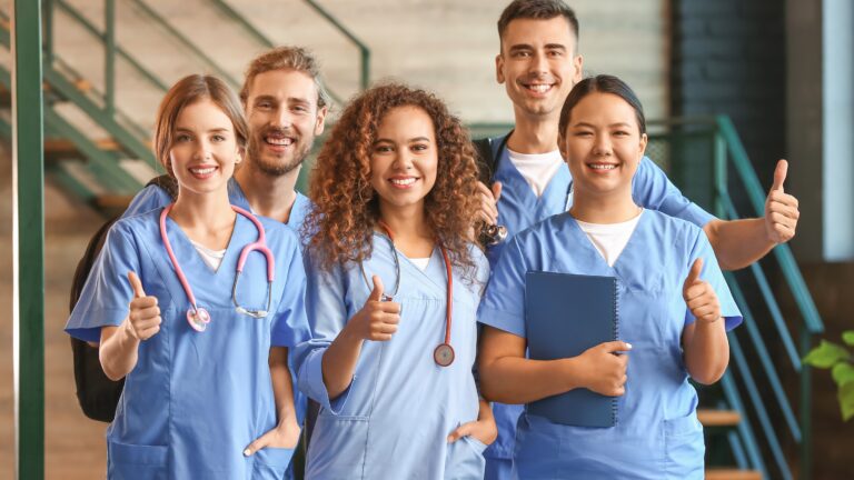 med students with thumbs up