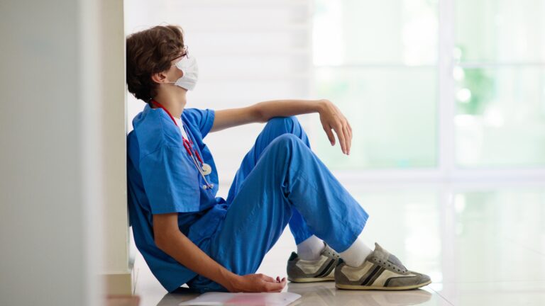 tired man sitting on floor