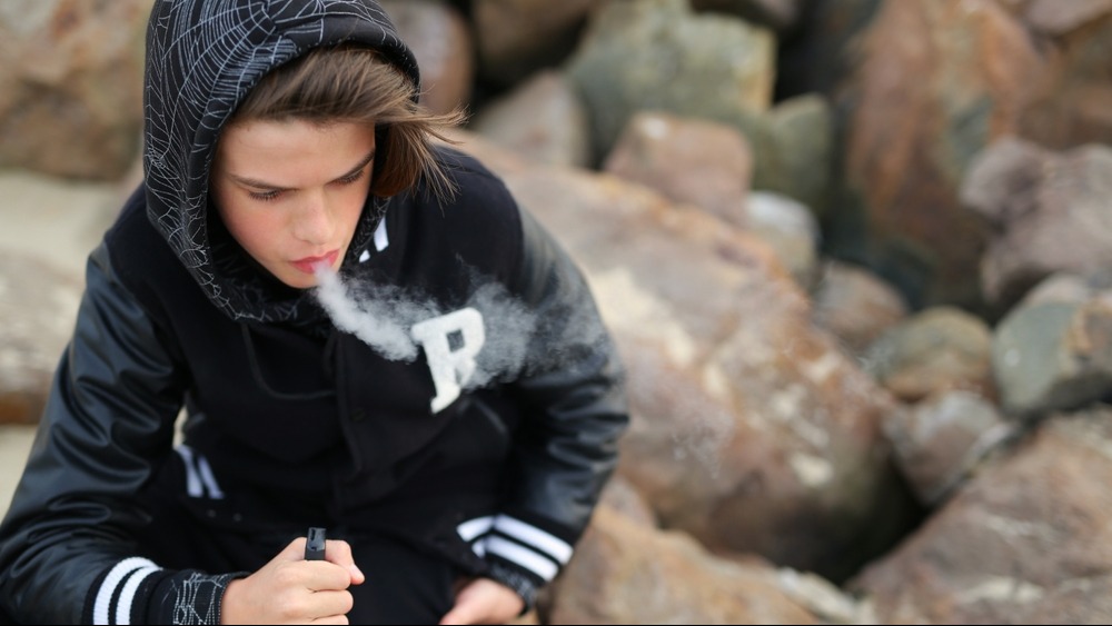 kid vaping on rocks
